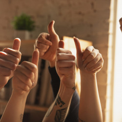 Close up of caucasian male and female hands showing nice, thumbs up